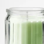 شمع معطر با ظرف شیشه‌ای، رنگ بژ ، رایحه وانیل IKEA LÖVSKOGSLUND - Image 2